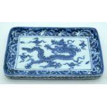 A Chinese blue and white ceramic tray decorated with a dragon 20 x 13cm.