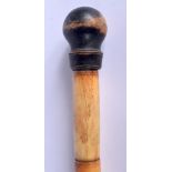 AN EARLY 20TH CENTURY CHINESE CARVED BONE WALKING CANE with spherical wood terminal. 83 cm long.