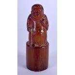 A RARE EARLY 20TH CENTURY CHINESE CARVED BUFFALO HORN SEAL Late Qing, modelled as a standing budd
