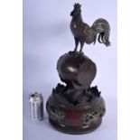 A LARGE 19TH CENTURY JAPANESE MEIJI PERIOD BRONZE OKIMONO modelled as a cockerel standing upon a dru