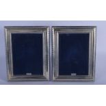 A PAIR OF 1970S ENGLISH SILVER PHOTOGRAPH FRAMES. 22 cm x 16 cm.