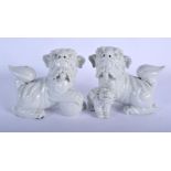 A PAIR OF 19TH CENTURY CHINESE PORCELAIN BUDDHISTIC LIONS modelled standing upon an orb and a young