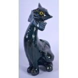 A SMALLER VINTAGE CHARLES BRANNAM POTTERY FIGURE OF A CAT modelled in a bowtie. 21 cm x 7 cm.