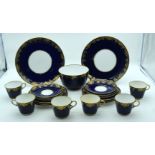 An antique part Copeland Cobalt blue dinner service with a gilded floral border 24.5cm (21)