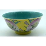 A Chinese yellow ground bowl with Famille Rose petal decoration 7 x 16cm.