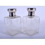 A PAIR OF ANTIQUE SILVER ENGRAVED GLASS BOTTLES. London 1916. Silver 96 grams. 15 cm x 8 cm.