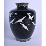 AN EARLY 20TH CENTURY JAPANESE MEIJI PERIOD ENAMEL VASE decorated with birds in flight. 19 cm high.