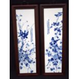 A pair of Chinese framed porcelain panels decorated with birds, flowers and calligraphy 73 x 20 cm