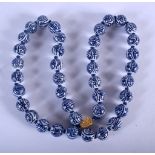 A CHINESE PORCELAIN NECKLACE 20th Century. 40 cm long.