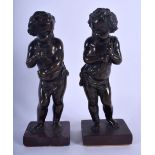 A PAIR OF 19TH CENTURY EUROPEAN BRONZE FIGURES OF PUTTI modelled upon red marble bases. 21 cm high.