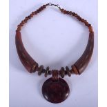 AN EARLY 20TH CENTURY MIDDLE EASTERN CARVED RHINOCEROS HORN NECKLACE of graduated form. 80 grams. 40