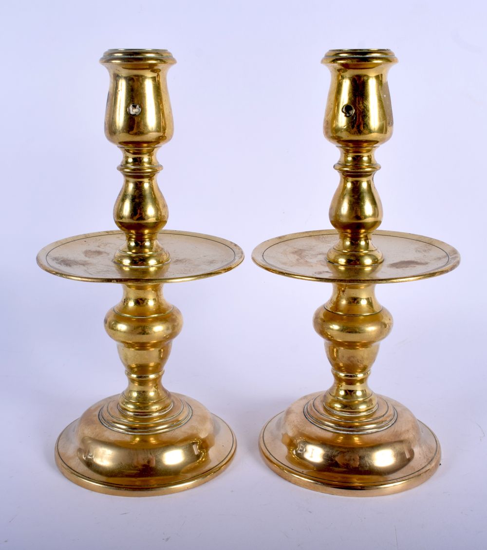 A PAIR OF 18TH CENTURY EUROPEAN BRASS CANDLESTICKS with circular drip trays. 23 cm high. - Image 2 of 3