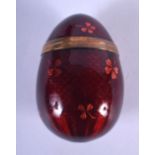 AN EARLY 20TH CENTURY EUROPEAN RED ENAMEL AND YELLOW METAL EASTER EGG. 6 cm x 3 cm.