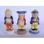 A SET OF THREE 19TH CENTURY STAFFORDSHIRE FIGURAL SALTS. 15 cm high. (3)