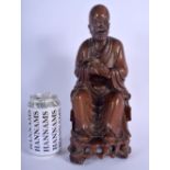 A 19TH CENTURY CHINESE CARVED HARDWOOD FIGURE OF A BUDDHA Qing, modelled upon an openwork base. 30 c