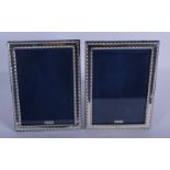 A PAIR OF 1970S ENGLISH SILVER PHOTOGRAPH FRAMES. 22 cm x 16 cm.