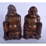 A PAIR OF 19TH CENTURY CHINESE CARVED HARDWOOD FIGURE OF BUDDHAS modelled upon openwork bases. 24 cm