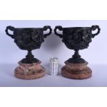 A LARGE PAIR OF 19TH CENTURY EUROPEAN TWIN HANDLED BRONZE URNS decorated in relief with figures. 34