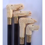 FOUR CONTINENTAL CARVED BONE WALKING CANES with ebonised shafts. Largest 95 cm long. (4)