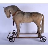 AN EARLY 20TH CENTURY CHILDS PLUSH HORSE PULL ALONG TOY. 60 cm x 54 cm.
