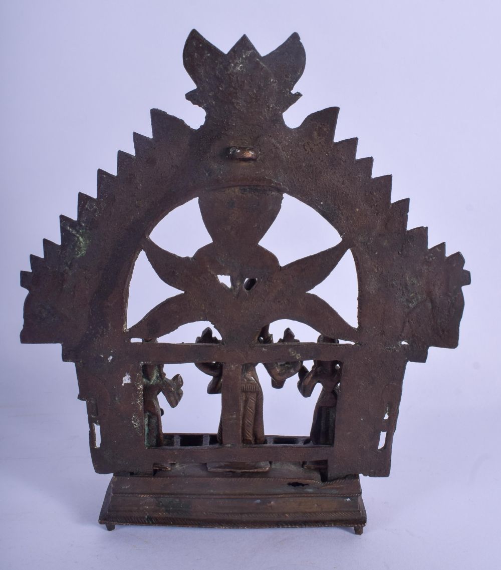 AN 18TH CENTURY INDIAN HINDU BUDDHISTIC BRONZE SHRINE modelled standing in front of a floral plate. - Image 3 of 4