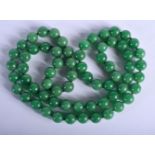 A CHINESE JADEITE NECKLACE 20th Century. 80 cm long, each bead 1 cm wide.