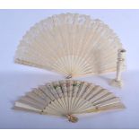 TWO ANTIQUE IVORY FANS and a candlestick. Largest 40 cm extended. (3)