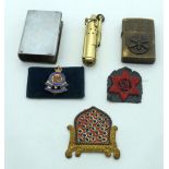 A Vietnam war Zippo lighter together with a 1917 metal vesta case, a lighter and military badges 6cm