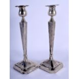 A PAIR OF LATE 19TH CENTURY CHINESE EXPORT SILVER CANDLESTICKS of hammered form. 750 grams overall.