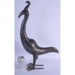 AN ANTIQUE PERSIAN SILVER INLAID METAL FIGURE OF A STANDING BIRD decorated with scrolling motifs. 54
