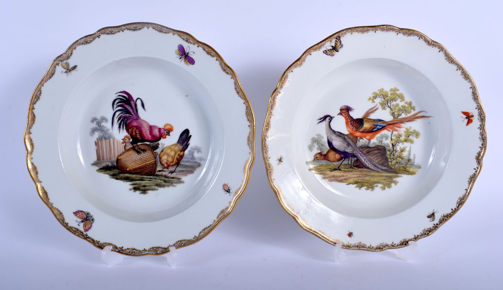 A PAIR OF 19TH CENTURY MEISSEN PORCELAIN BARBED BOWLS painted with fowl and exotic birds within land