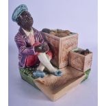 AN UNUSUAL EUROPEAN PAINTED POTTERY FIGURE OF A CUBAN modelled beside 2 crates of fruit. 15 cm x 12
