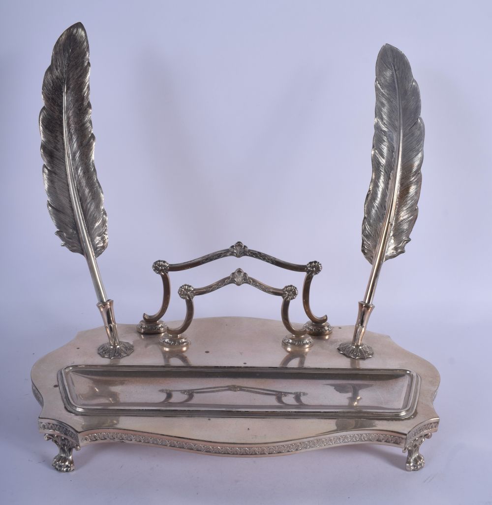 AN EARLY 20TH CENTURY CONTINENTAL WHITE METAL INKWELL of scrolling form with 2 feather quills. 26 cm