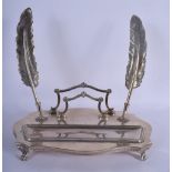 AN EARLY 20TH CENTURY CONTINENTAL WHITE METAL INKWELL of scrolling form with 2 feather quills. 26 cm