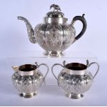 AN ANTIQUE INDIAN THREE PIECE SILVER TEASET. 858 grams. Largest 24 cm x 18 cm. (3)