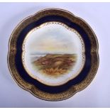 Coalport plate painted with a landscape under a blue and gilt border by P. Simpson, signed. 24cm di