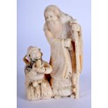 A 19TH CENTURY JAPANESE MEIJI PERIOD CARVED IVORY OKIMONO modelled as two immortals. 9 cm x 5 cm.