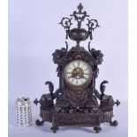 A LARGE 19TH CENTURY FRENCH BRONZE MANTEL CLOCK decorated with mask heads and foliage. 48 cm x 20 cm