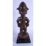 AN AFRICAN TRIBAL YORUBA HARDWOOD FIGURE. 29 cm high overall.