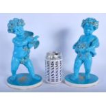 A PAIR OF 19TH CENTURY SEVRES STYLE TURQUOISE BLUE GLAZED PORCELAIN FIGURES one modelled holding ber