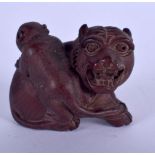 A JAPANESE CARVED BOXWOOD NETSUKE modelled as a Buddhistic lion. 4 cm x 3 cm.