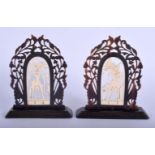 A VERY RARE PAIR OF 19TH CENTURY ANGLO INDIAN CARVED RHINOCEROS HORN BOOKENDS inset with ivory deiti
