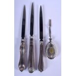 THREE SILVER HANDLED PAPER KNIVES and a white metal perfume flask. Largest 18 cm long. (4)