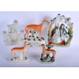 A LARGE 19TH CENTURY STAFFORDSHIRE FIGURE OF A GREYHOUND together with four other similar figures. L