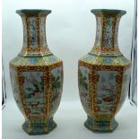 A pair of large Chinese Famille Jeune vases decorated with animals in a landscape