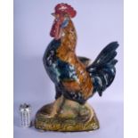 A LARGE 19TH CENTURY CONTINENTAL MAJOLICA FIGURE OF A ROAMING COCK modelled upon a naturalistic base