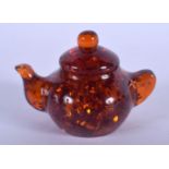 A CHINESE CARVED AMBER TEAPOT AND COVER 20th Century. 79 grams. 6.5 cm wide.