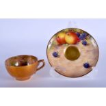 Royal Worcester demi-tasse cup and saucer painted with fruit, the saucer by J. Freeman, signed, the