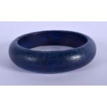 A CHINESE CARVED LAPIS LAZULI BANGLE 20th Century. 7 cm diameter.