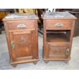 A pair of Edwardian carved panel Oak bedside cabinets with a porcelain cooling box and marble tops.